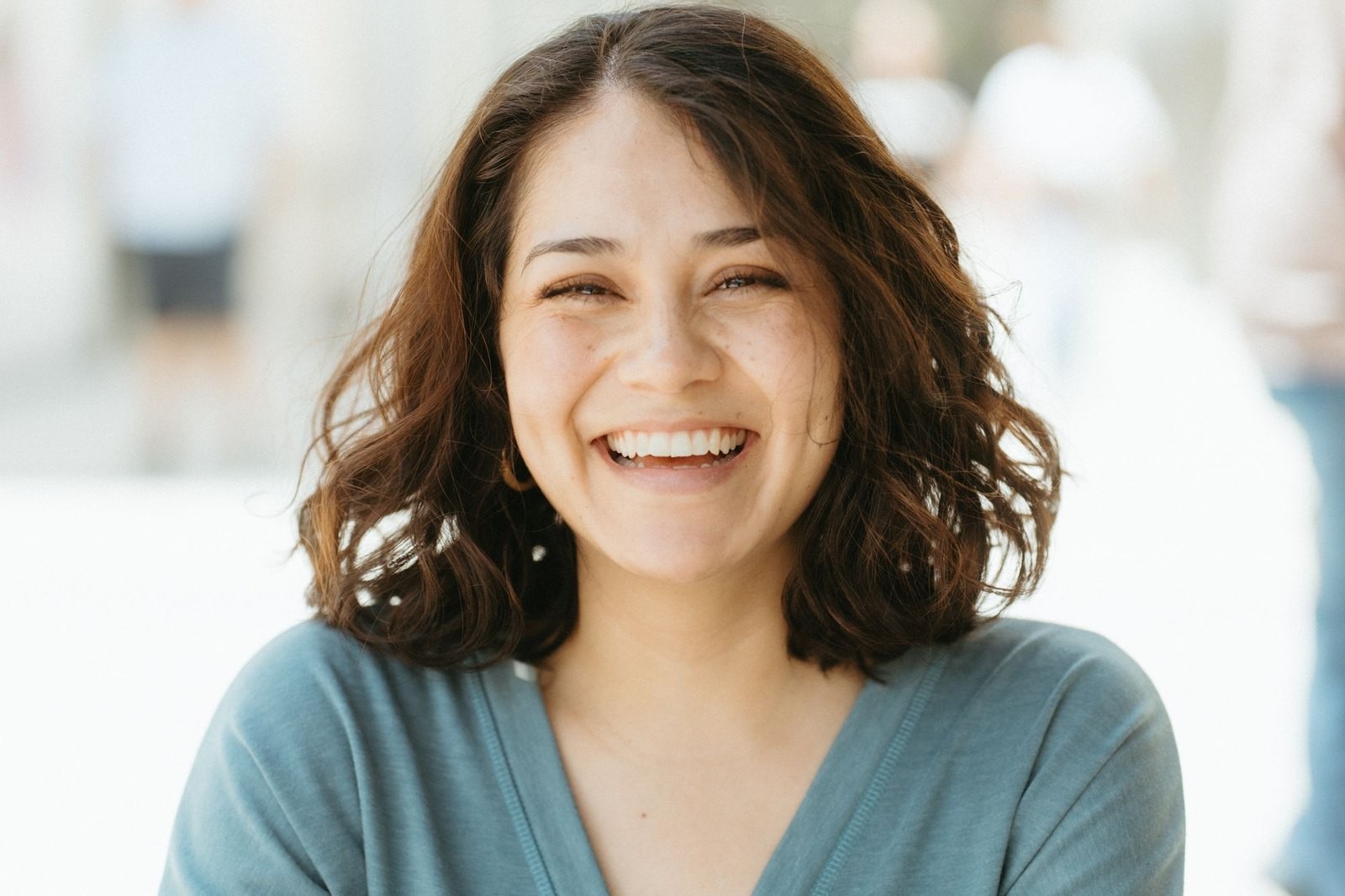 A woman smiling in natural daylight