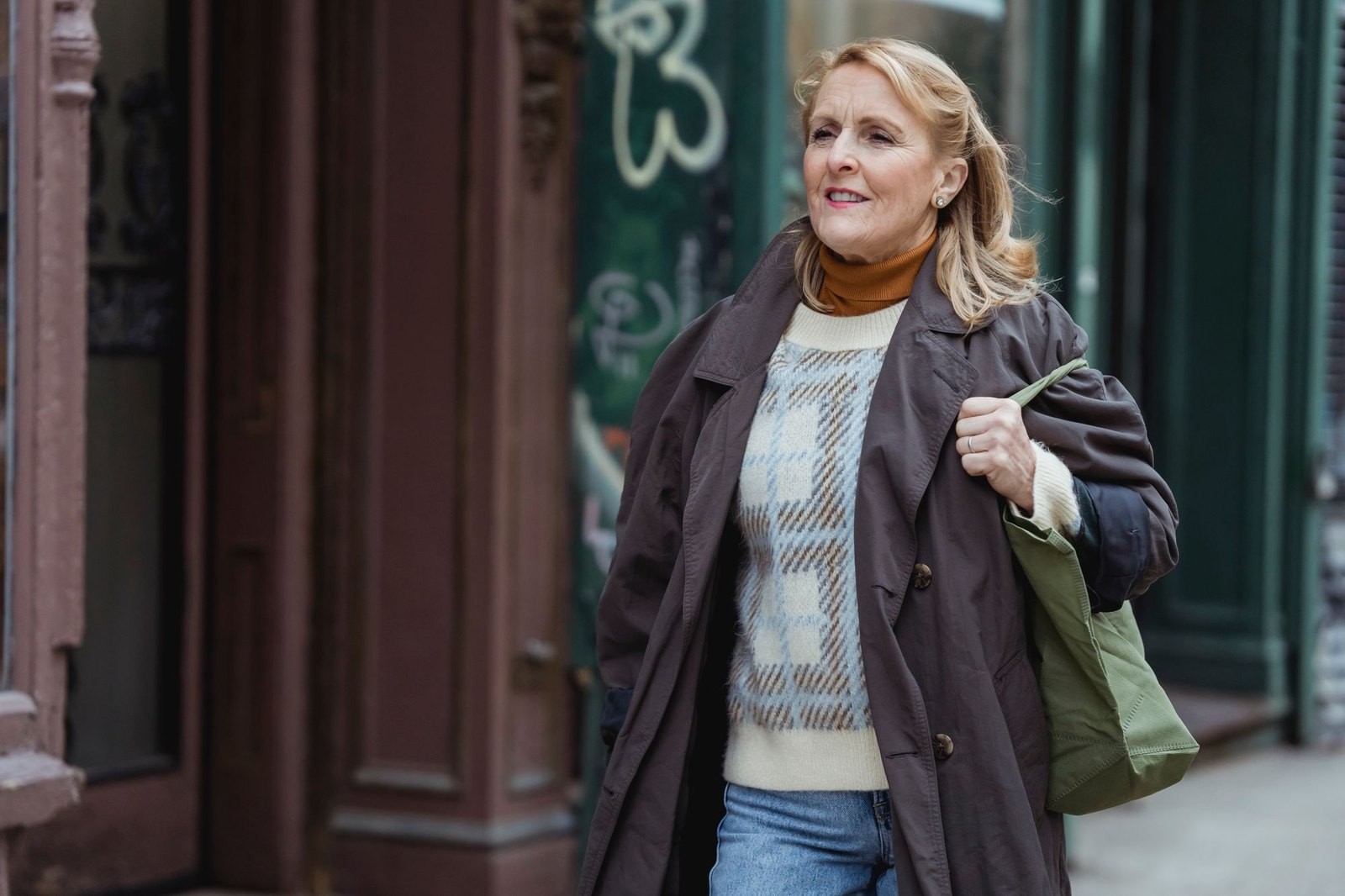 A woman walking through town with a tote bag
